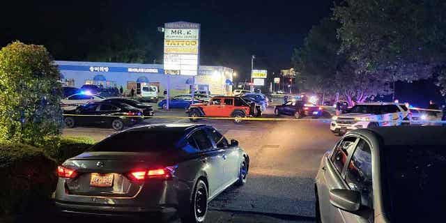 Police are shown working on the scene of a shooting near the V Luxx Hookah Lounge in Fayetteville, North Carolina, on April 3, 2023. One person was killed, and four others were injured in the shooting.
