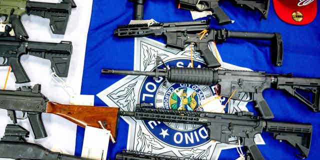 Firearms that were seized from a multiagency operation targeting the Westside Verdugo criminal street gang are displayed during a press conference on Dec. 9, 2021, in San Bernardino, California. Law enforcement seized 54 ghost guns from people who weren't allowed to own guns in California last year.