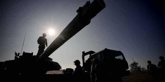 A French serviceman stands on a Leclerc main battle tank during a joint French US exercise involving HIMARS and MLRP rocket launchers and at a firing range in Capu Midia, on the Black Sea shore, Romania, Thursday, Feb. 9, 2023.