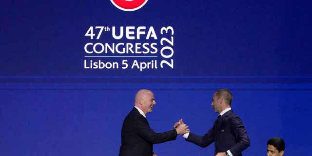 Gianni Infantino, left, president of FIFA, shakes hands with Aleksander Ceferin, president of UEFA, after delivering a speech at the start of the 47th ordinary UEFA congress in Lisbon, on April 5, 2023. Ceferin is looking to cut down on abuse of players by allowing clubs to push for criminal prosecution of racist, sexist, and homophobic fans.