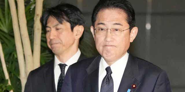 Japans Prime Minister Fumio Kishida, right, meets reporters after an army helicopter went missing, at his official residence in Tokyo on April 6, 2023.