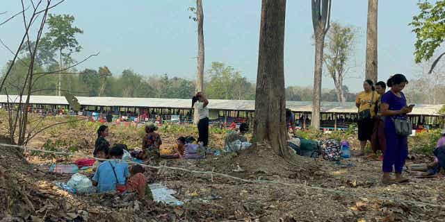 Residents from eastern Myanmar are seen after fleeing into Thailand's Tak Province on April 6, 2023. More than 5,000 people have fled from Myanmar into Thailand in recent days.