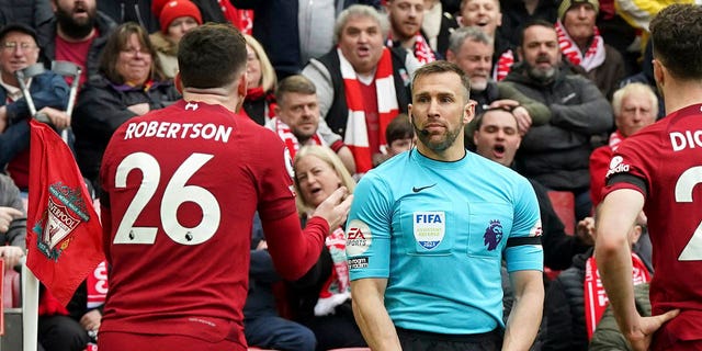 Liverpool's Andrew Robertson appeals to assistant referee Constantine Hatzidakis during the Premier League match between Liverpool and Arsenal at Anfield, Liverpool, Britain, Sunday April 9, 2023. 