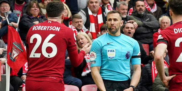 Liverpool's Andrew Robertson appeals to assistant referee Constantine Hatzidakis during the Premier League match between Liverpool and Arsenal at Anfield, Liverpool, Britain, Sunday April 9, 2023.