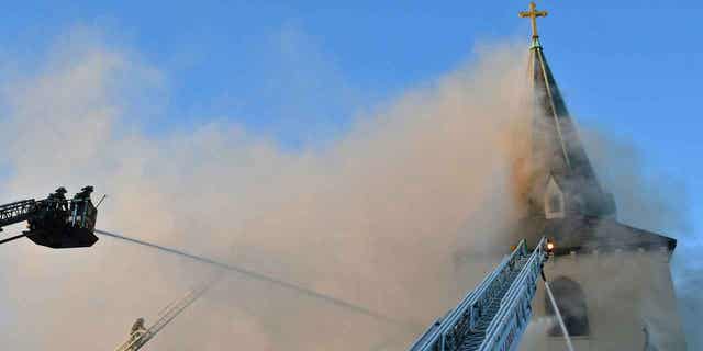 Firefighters work on a fire at Faith Lutheran Church in Cambridge, Massachusetts, on April 9, 2023. Over 100 firefighters helped save the 114-year-old church.