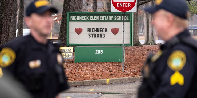 Police look on as students return to Richneck Elementary School on Jan. 30, 2023, in Newport News, Virginia. Prosecutors are probing whether school administrators should face charges after a teacher was shot by a first-grade student in class.