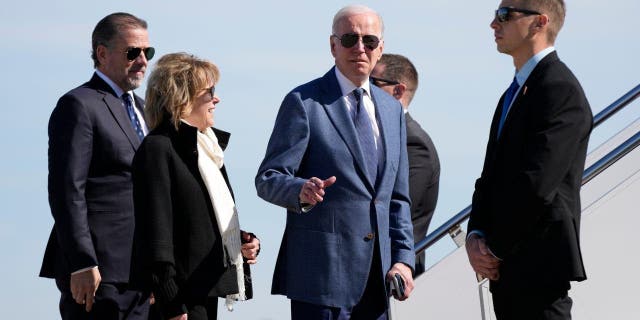 President Joe Biden gestures before he walked over to talk with reporters before boarding Air Force One, Tuesday, April 11, 2023, at Andrews Air Force Base, Md. 