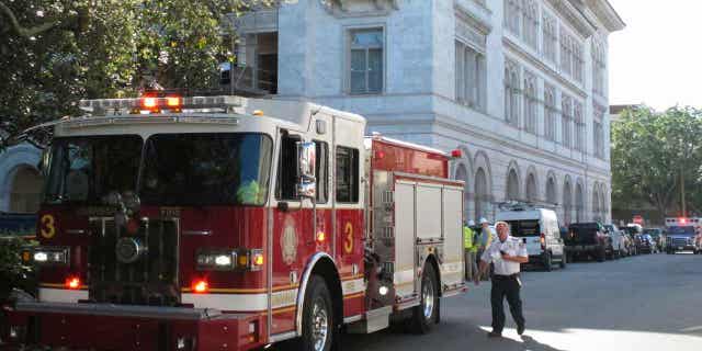 A firetruck sits outside the federal courthouse in Savannah, Georgia, on April 11, 2023, after part of an upper floor collapsed and injured three construction workers.
