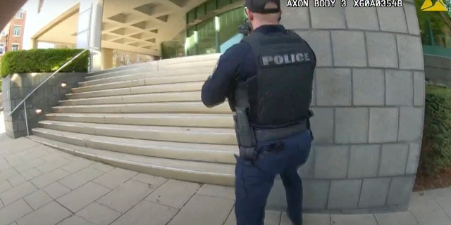 In this screengrab taken from the bodycam video of Louisville Metro Police Department Officer Nickolas Wilt, fellow Officer Cory Galloway approaches an active-shooting situation at Old National Bank in Louisville, Kentucky, on April 10, 2023.