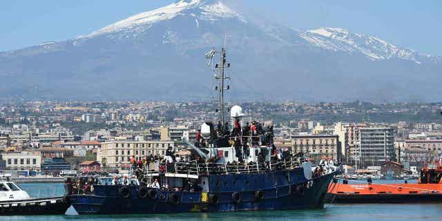 A ship carrying around 700 migrants enters the Sicilian port of Catania, on April 12, 2023. The United Nation migration agency reported 2023 has been a deadly year for migrants crossing the central Mediterranean Sea.