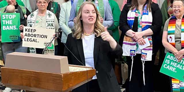 Nebraska state Sen. Megan Hunt addresses a crowd on April 12, 2023, in Lincoln, Nebraska, during a rally to oppose a bill that would ban abortion once cardiac activity can be detected in an embryo, which is generally around the sixth week of pregnancy.Â