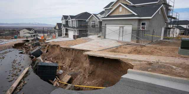 Local officials issued evacuation orders for at least 20 homes as temperatures spiked and snowmelt coursed through the streets on, April 12, 2023, in Kaysville, Utah. A record-breaking snow season has raised fears of spring flooding from the Rockies to the Southwest as the weather warms.
