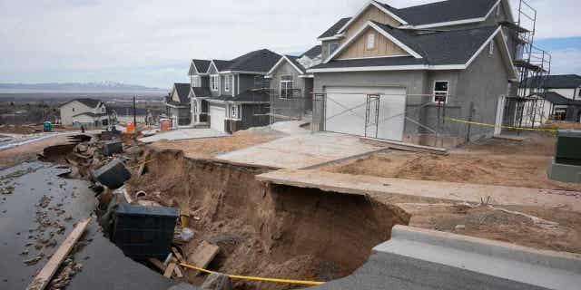 Local officials issued evacuation orders for at least 20 homes as temperatures spiked and snowmelt coursed through the streets on, April 12, 2023, in Kaysville, Utah. A record-breaking snow season has raised fears of spring flooding from the Rockies to the Southwest as the weather warms.