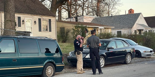 Anthony Krock, a public information officer with the Fort Wayne Police Department, talks with an officer on the scene of a shooting that broke out during a memorial at McCormick Park on Wednesday, April 12, 2023, in Fort Wayne, Indiana.
