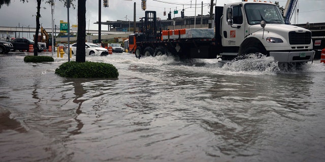 Exit 2 off of the MacArthur Causeway floods over the road and onto the sidewalk during a rainstorm, Wednesday, April 12, 2023, in Miami.