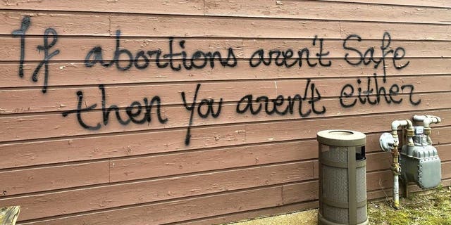 Threatening graffiti is seen on the exterior of the Wisconsin Family Action offices in Madison, Wisconsin, on May 8, 2022.