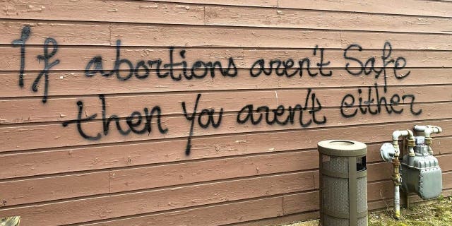 Threatening graffiti is seen on the exterior of the Wisconsin Family Action offices in Madison, Wisconsin, on May 8, 2022.