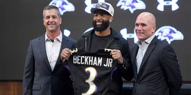 Newly signed Baltimore Ravens wide receiver Odell Beckham Jr., center, stands with head coach John Harbaugh, left, and general manager Eric DeCosta during a news conference at the team's practice facility in Owings Mills, Maryland on Thursday, April 13, 2023. 