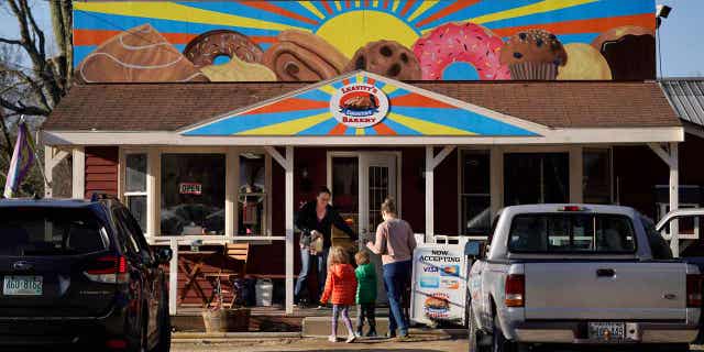 A family arrives at Leavitts Country Bakery, on April 13, 2023, in Conway, New Hampshire. The large painting created by students and displayed over the bakery is at the center of a legal battle pitting a zoning ordinance against freedom-of-speech rights.