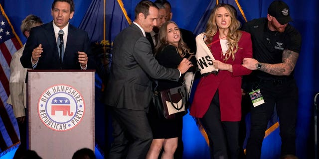 A protester interrupts an address by Florida Gov. Ron DeSantis during a stop at a New Hampshire Republican Party dinner, Friday, April 14, 2023, in Manchester, N.H.