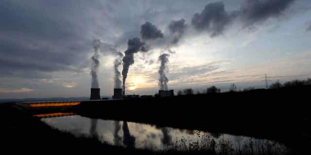 Smoke rises from chimneys of the Turow power plant near the town of Bogatynia, Poland, on Nov. 19, 2019. A scheme to develop small nuclear power reactors in Poland is moving forward, with an agreement between two U.S. government financial institutions and the Polish energy giant ORLEN.