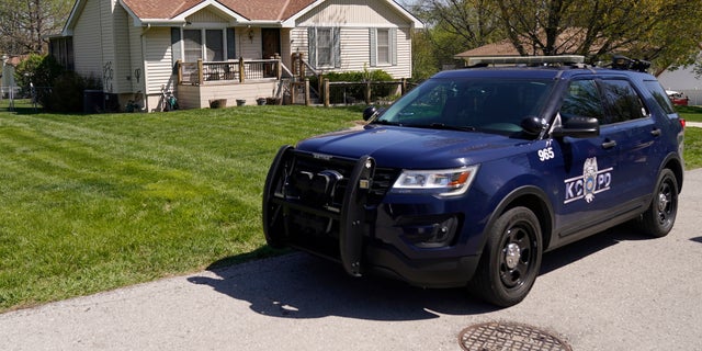 A police officer on Monday drives past the house in Kansas City where 16-year-old Ralph Yarl was shot last Thursday.