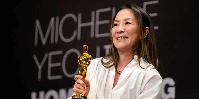 Actress Michelle Yeoh holds up her Oscar award during a press conference in Kuala Lumpur, Malaysia, on April 18, 2023. Yeoh won the award for best performance by an actress in a leading role for "Everything Everywhere All at Once." 