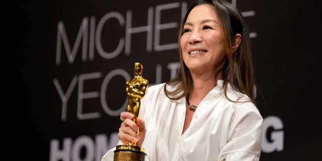 Actress Michelle Yeoh holds up her Oscar award during a press conference in Kuala Lumpur, Malaysia, on April 18, 2023. Yeoh won the award for best performance by an actress in a leading role for "Everything Everywhere All at Once."
