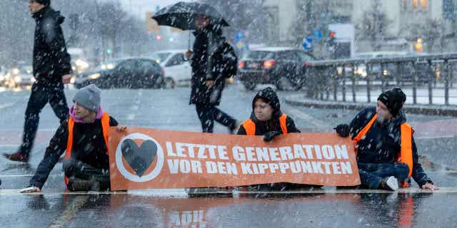 Activists of the "Last Generation" are pictured sitting on a street in Dresden, Germany, on Jan. 20, 2023. The group announced they will stage more protests in Berlin in an effort to force the government into doing more to curb global warming.