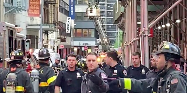 NYPD and FDNY personnel cordon off an area in New York's Financial District, Tuesday, April 18, 2023, near the site of a partially collapsed parking garage.