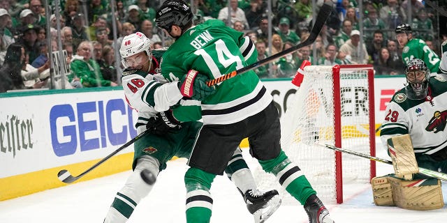 Jared Spurgeon takes a hit from Jamie Benn