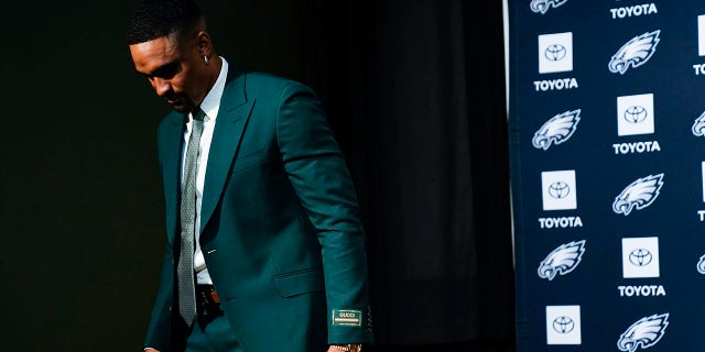 Jalen Hurts walks into a press conference following his contract extension
