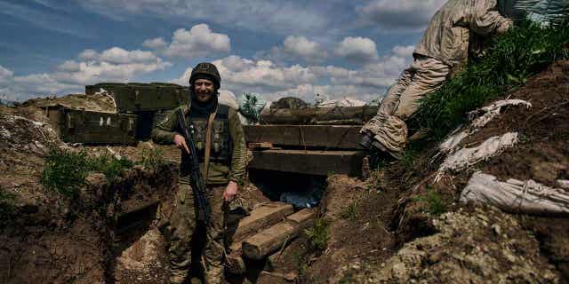 A Ukrainian soldier smiles 