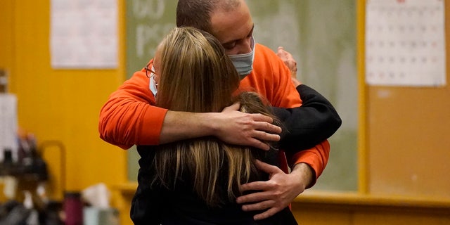 Nima Momeni, right, hugs his attorney, Paula Canny