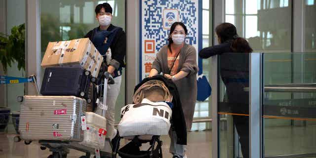 Travelers wearing face masks