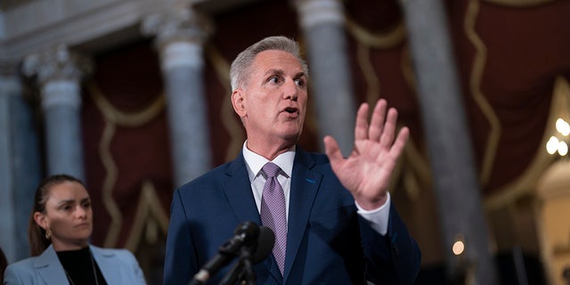 Speaker of the House Kevin McCarthy speaks with a raised hand