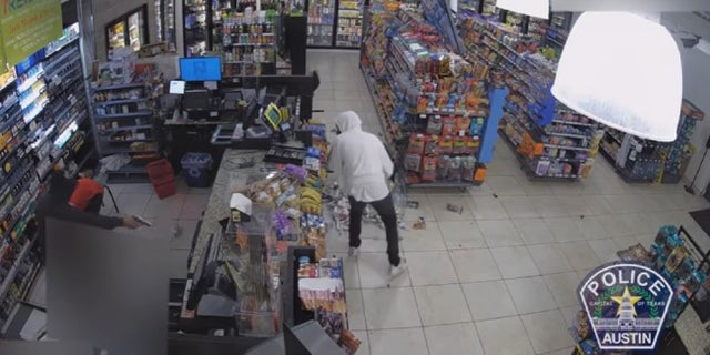 A suspect shoots at a 7-Eleven store safe during a March 29 robber in Austin, Texas.