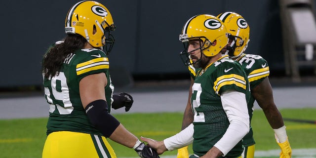 Aaron Rodgers (12) of the Green Bay Packers greets David Bakhtiari (69) prior to a game against the Chicago Bears at Lambeau Field Nov. 29, 2020, in Green Bay, Wis.