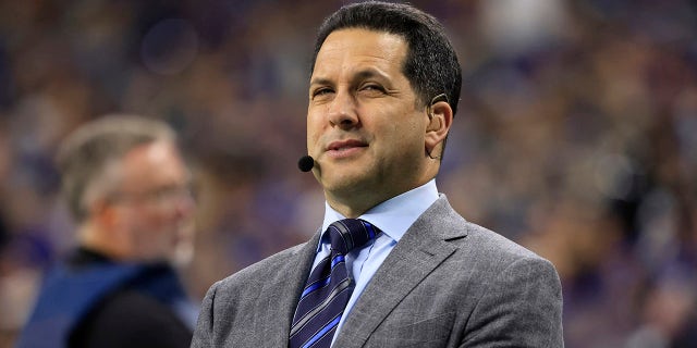 Adam Schefter looks on field