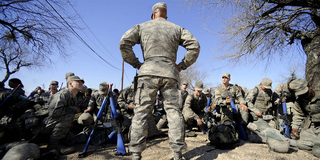 Master Sgt. Tim Burton prepares trainees for gas mask training at the Basic Expeditionary Airman Skills Training program in Medina AB, San Antonio, Texas, in February 2009. The Air Force is now loosening the body fat requirements for new recruits.