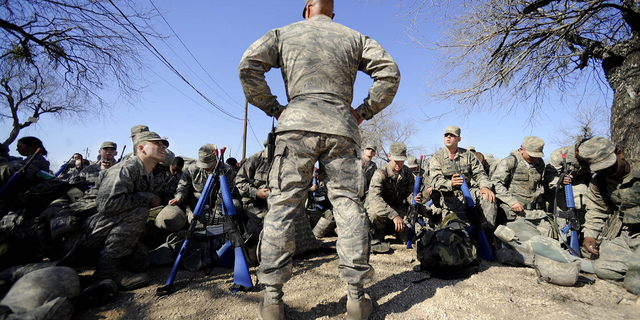 Master Sgt. Tim Burton prepares trainees for gas mask training at the Basic Expeditionary Airman Skills Training program in Medina AB, San Antonio, Texas, in February 2009. The Air Force is now loosening the body fat requirements for new recruits.