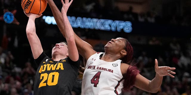 Iowa's Kate Martin tries to shoot past South Carolina's Aliyah Boston during the first half of an NCAA Women's Final Four basketball game Friday, March 31, 2023, in Dallas. 