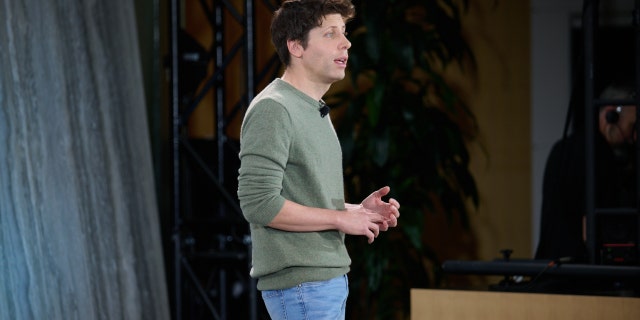 Sam Altman standing