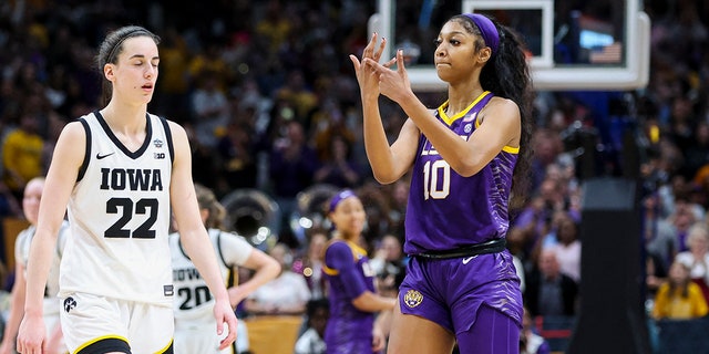 April 2, 2023;  Dallas, TX, USA;  LSU Lady Tigers forward Angel Reese (10) points to Iowa Hawkeyes guard Caitlin Clark (22) after the final round of the Women's Final Four NCAA Tournament at the American Airlines Center.