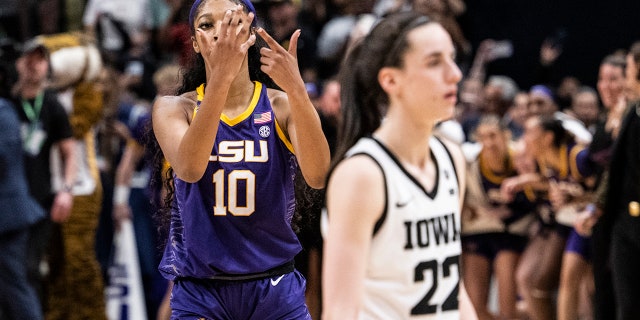 Angel Reese #10 of the LSU Lady Tigers reacts in front of Caitlin Clark #22 of the Iowa Hawkeyes towards the end of the 2023 NCAA Women's Basketball Tournament championship game at American Airlines Center on April 02, 2023 in Dallas, Texas.