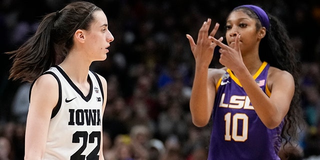 LSU's Angel Reese reacts in front of Iowa's Caitlin Clark during the NCAA championship game Sunday, April 2, 2023, in Dallas.