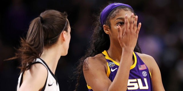 Angel Reese of the LSU Lady Tigers reacts toward Caitlin Clark of the Iowa Hawkeyes during the NCAA Women's Basketball Tournament championship game at American Airlines Center on April 2, 2023, in Dallas.