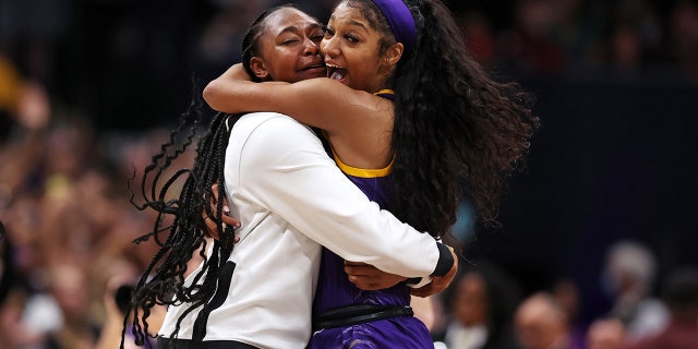 Angel Reese, #10 of the LSU Lady Tigers, celebrates with a teammate after defeating the Iowa Hawkeyes 102-85 during the 2023 NCAA Women's Basketball Tournament championship game at American Airlines Center on April 2, 2023 in Dallas.