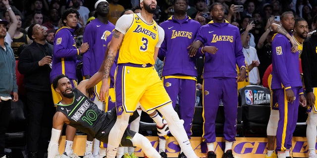 Minnesota Timberwolves guard Mike Conley is fouled, on a 3-point shot, by Lakers forward Anthony Davis during the play-in tournament game Tuesday, April 11, 2023, in Los Angeles.