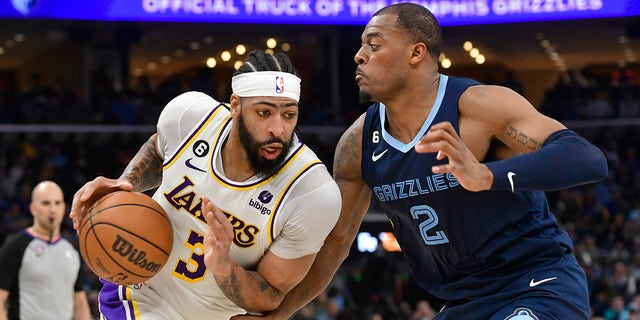 Los Angeles Lakers forward Anthony Davis (3) drives against Memphis Grizzlies forward Xavier Tillman (2) during Game 1 of a first-round NBA basketball playoff series Sunday, April 16, 2023, in Memphis, Tenn.